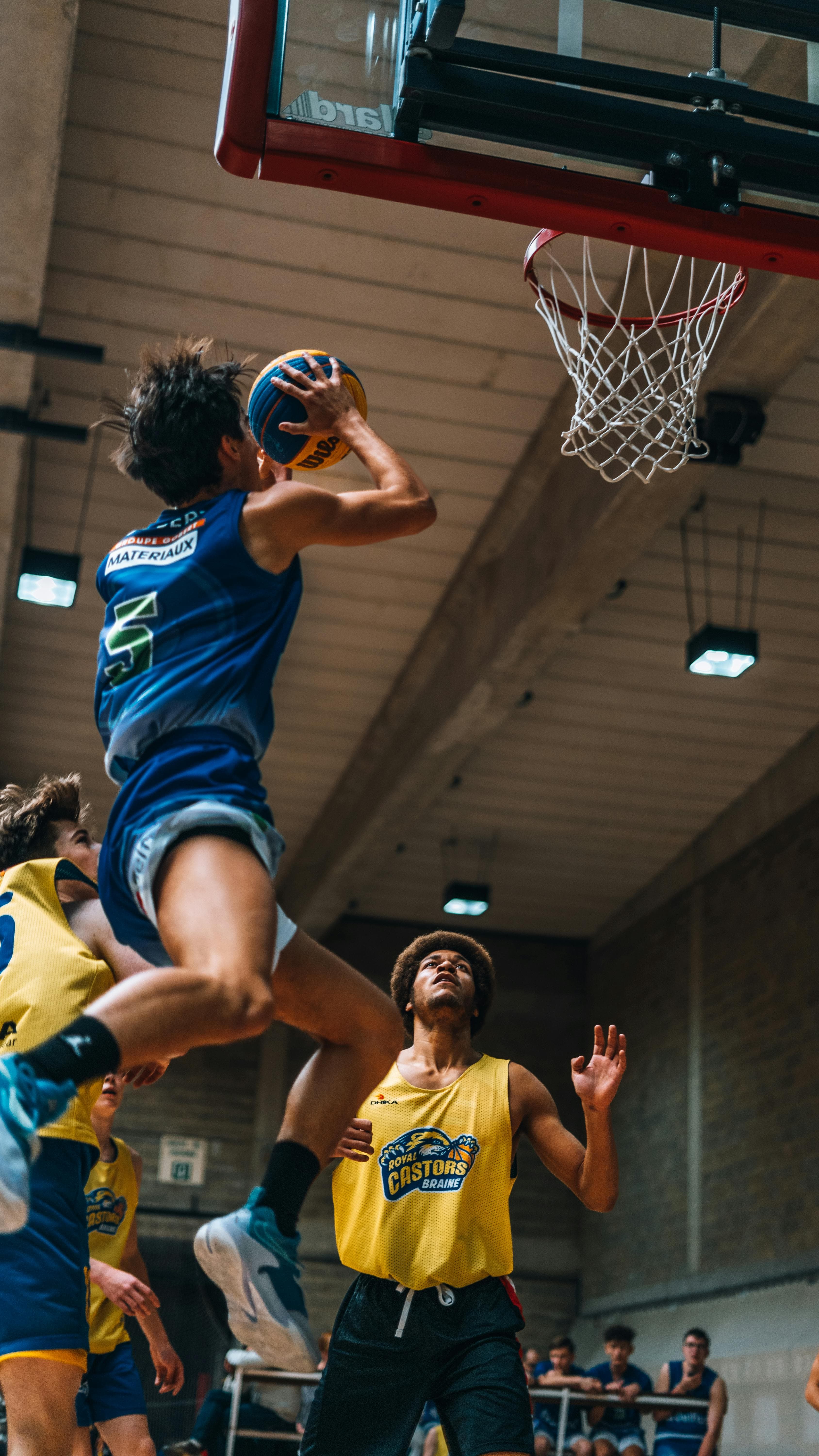 Basketball player rising toward the rim during a game